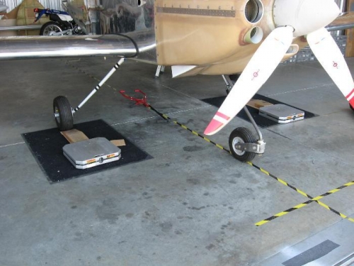 Aircraft with two of the three scales in place just prior to weighing