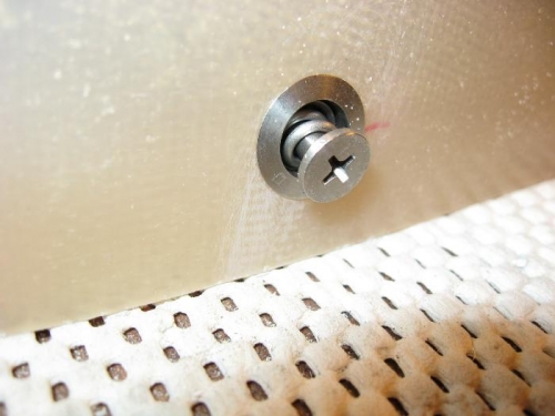 A spring-loaded fastener in the cowling