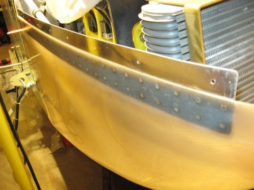 The darkened area is the ProSeal curing which is sandwiched between the fiberglass and attach strip