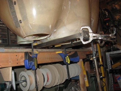 A view of the jig holding the cowling up on the workbench with room underneath to work.