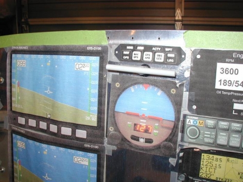 The release handle protruding through the paper templates on the panel