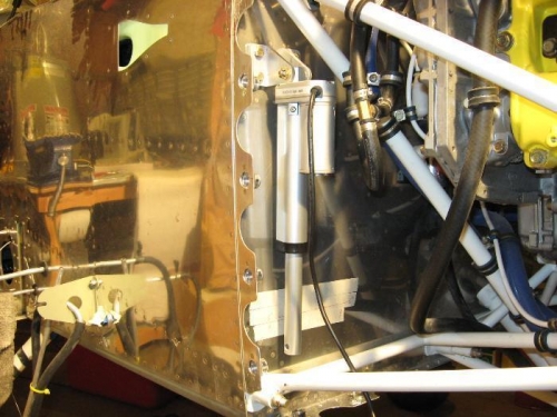 Hanging loose.  In it's working position, it will angle about 25 degrees away from the firewall