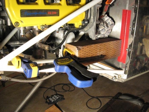 Using a 4x4 with a clamp reversed (light pressure) to hold back-rivet plate to firewall.