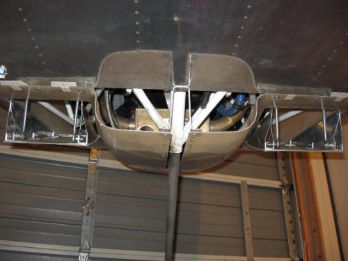 Open position with two linkage arms each for stability.  Inside sidewall bends to clear engine mounts.