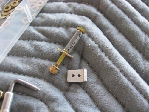 Spacer and control stop for one aileron