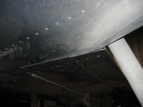 Right flap in the up position just kissing the bottom of the fuselage