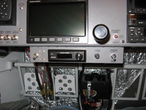 Cowl Flap switch on the left and Prop Controller in the center