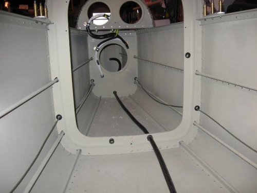 A look towards the back with conduit along floor