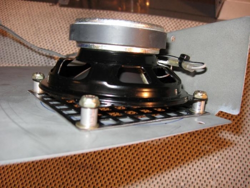 Speaker mounted with stand-offs to back of access panel