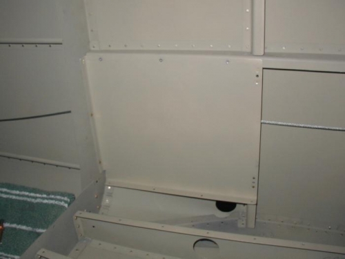 Left side F-750 Aft Baggage panel.  Note the rudder cable passing behind.