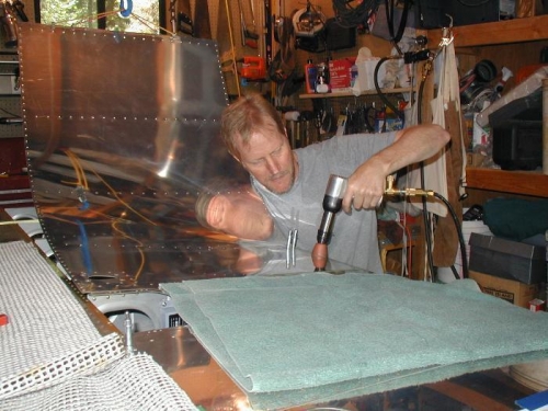 Riveting home one of the rivets along the rear spar