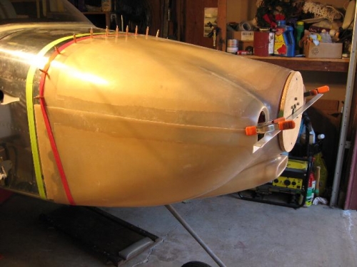 Lower cowl held up with a strap in back.  Bottom edge cut is first