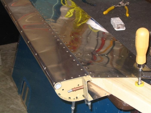 Aileron clamped to table for riveting upper spar