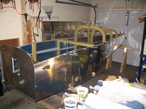 Riveting finished, fuselage resting on lowered sawhorse