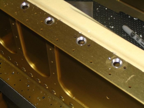 Countersunk holes w/ tape to deflect shavings