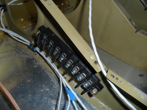 Terminal block attached to seat rib