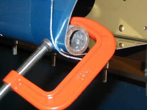 Aileron counterweight clamped in place