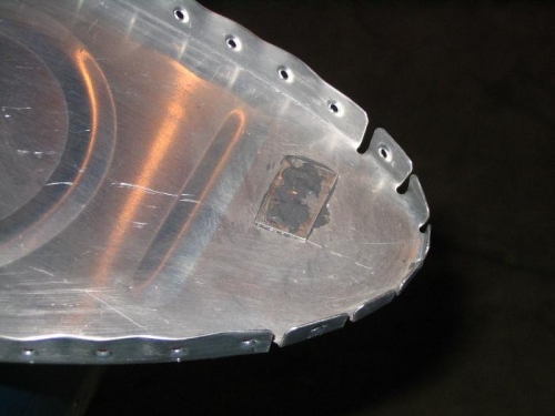 Tooling hole covered with plate