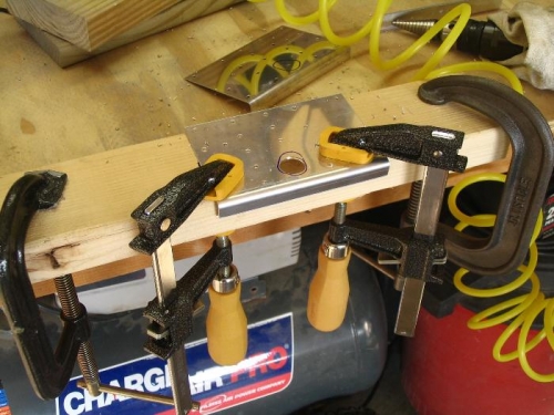 Cutting aileron actuator hole in reinforcement plate