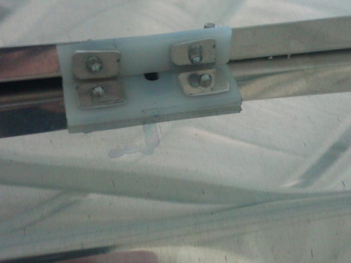 Reverse of aft baggage bulkhead shoulder harness carry through point