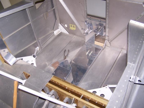 Floor pan and fuel selector bracket