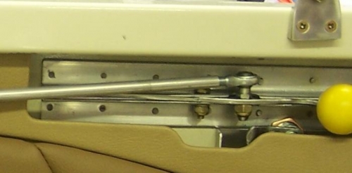 Lock arm just behind yellow knob