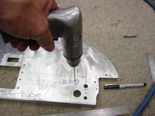 Located the hole for my glove box here I am drilling holes in all four corners for cutting.