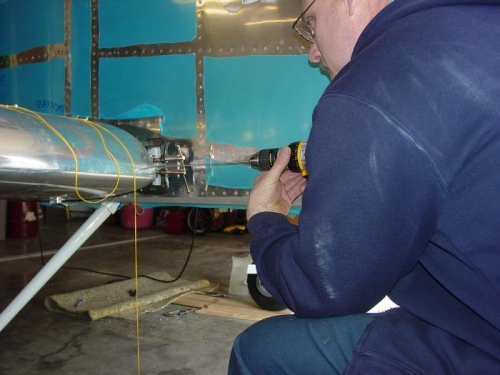 Here I am drilling through the fuel tank bracket and the fuselage bracket.