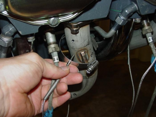 Instaling EGT lead into hole in exhaust pipe.