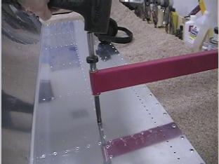 Dimpling the fuel tank skin.