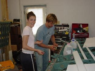 Erin and L.J. puting in rivits and securung them with rivit tape