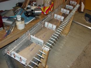 Showes the attach brackets and baffel clecoed to the tank.