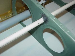 Closeup of conduit going through rib after being pro sealed.