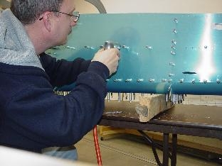 Here I am drilling into the J channel through the matched holes.