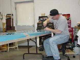 Deburing one of the side skins.