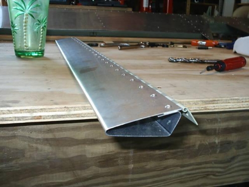 Elevator trim tab bent and riveted