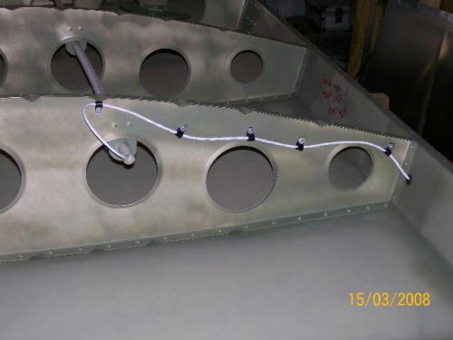 Aileron trim wiring exiting conduit