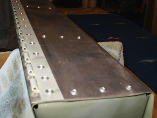 Hinge riveted in place