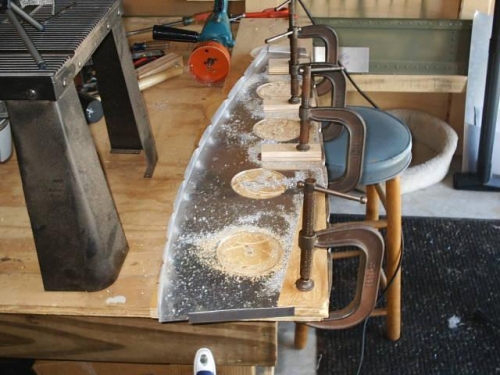 Rib clamped down for hole-cutting