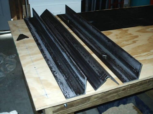 Brake parts cut to size, hinge relief slots trimmed. The powdery-looking coating is dried Ospho.