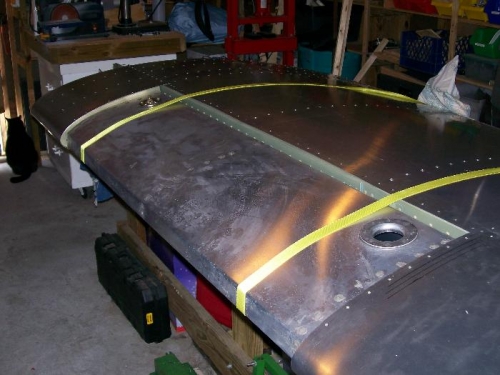 Left tank placement using straps