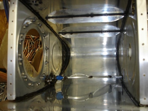 Inboard rib sealed and riveted in place