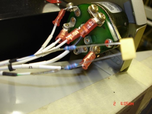 Soldered a piece of #22 wire to the tail of the resistors then heat shrink and cable ties