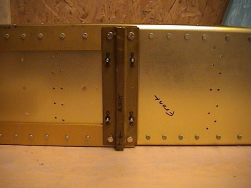 Tie down etch primed and bolted to spar