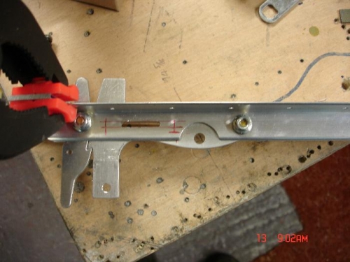 First I made a slot through the latch mechanism