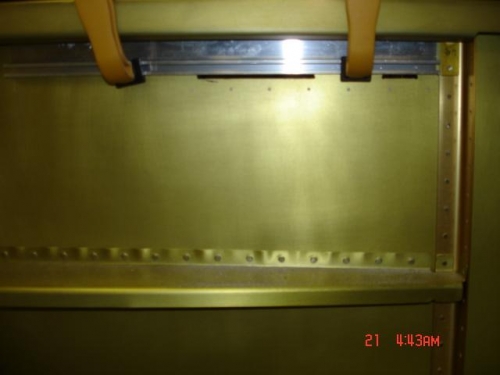 I clamped a straight edge behind the skin to guide the needle file