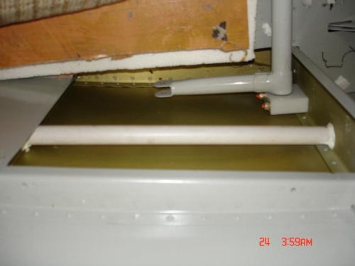 The simple fix is a plastic tube to cover the cable between the two bulkheads