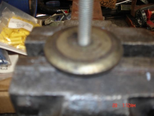 Dished washer over a bolt held in the vice