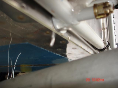 Lower cowl hinge pin secured through flange