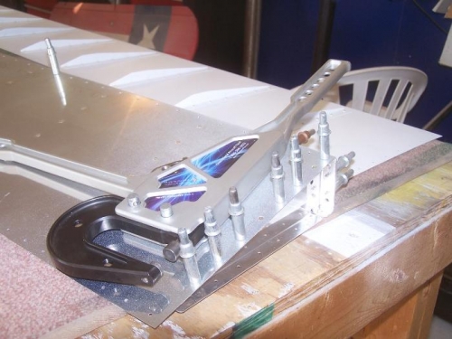 Temporarily riveting the bottom skins to the spar assemblies.